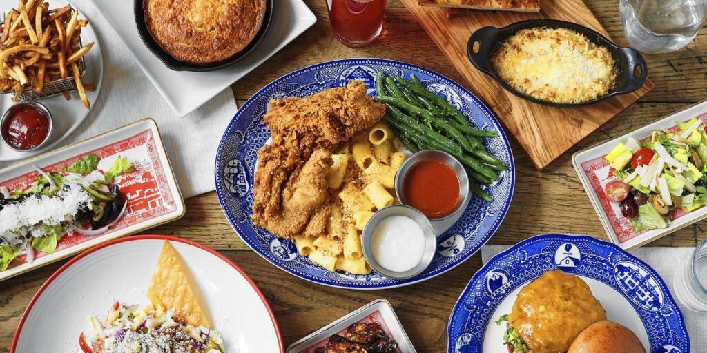 A spread of American food that includes fried chicken and mac & cheese.