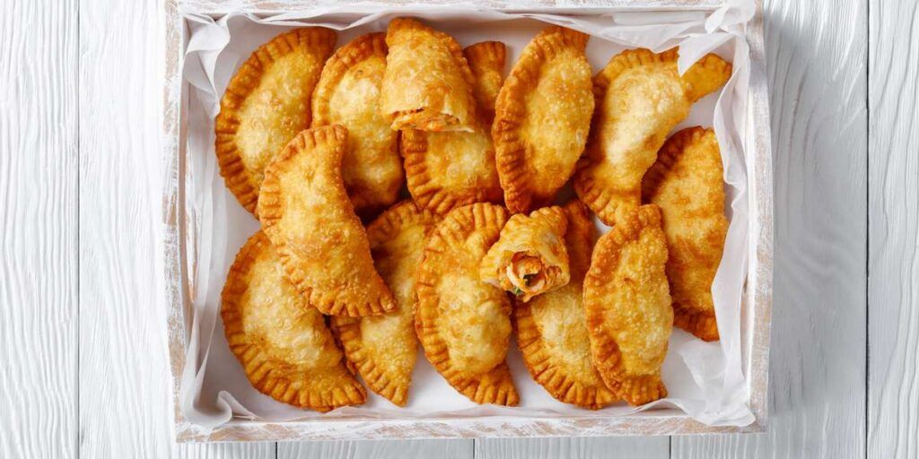 A bunch of empanadas in a box.