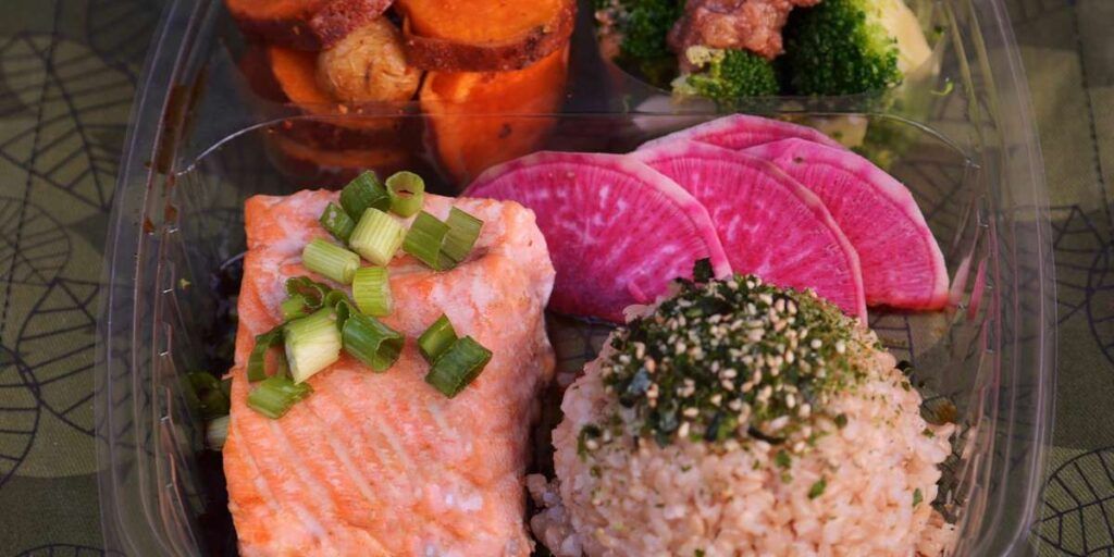 A bento box with sushi and rice.