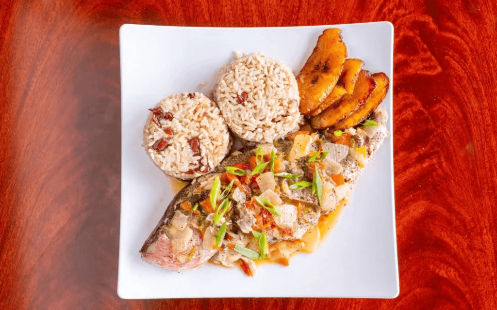 A Jamaican fish plate with rice and plantains.